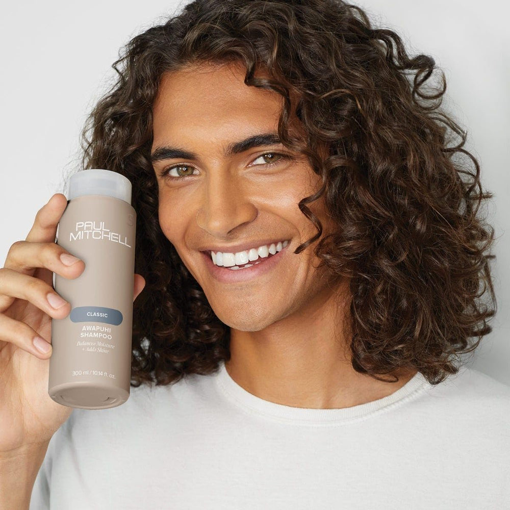 Paul Mitchell Awapuhi Shampoo bottle close-up emphasizes color-safe cleansing.