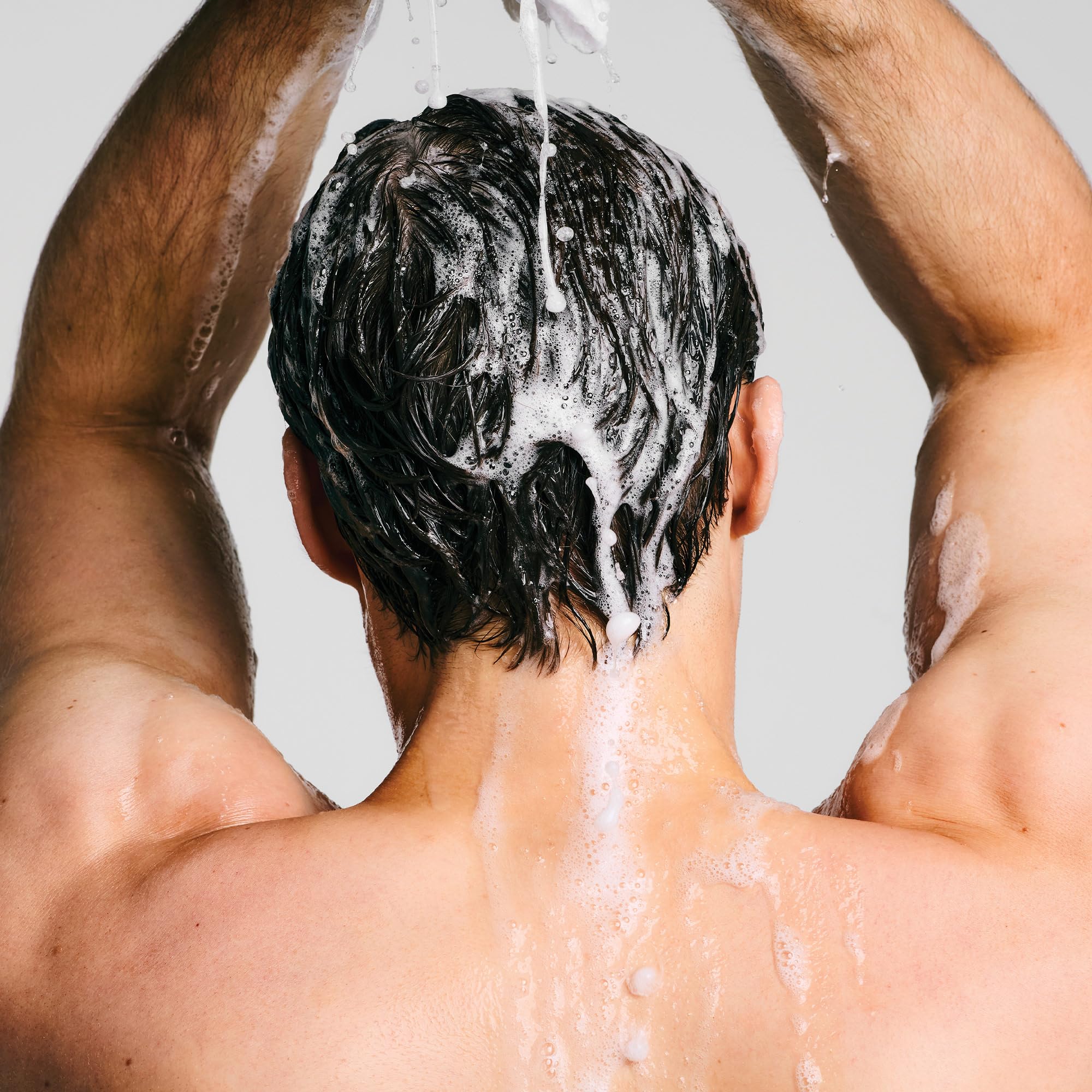 Paul Mitchell Clear Essential Shampoo fragrance-free bottle against clean backdrop for sensitive-skin use.