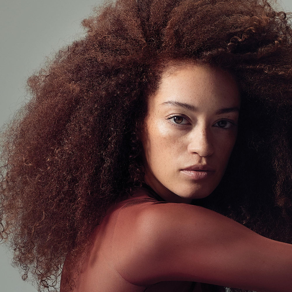 Paul Mitchell Hydrating Foam foamy texture showing curl definition.
