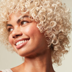 Paul Mitchell Violet Shampoo foamy lather enhances light blonde shine.