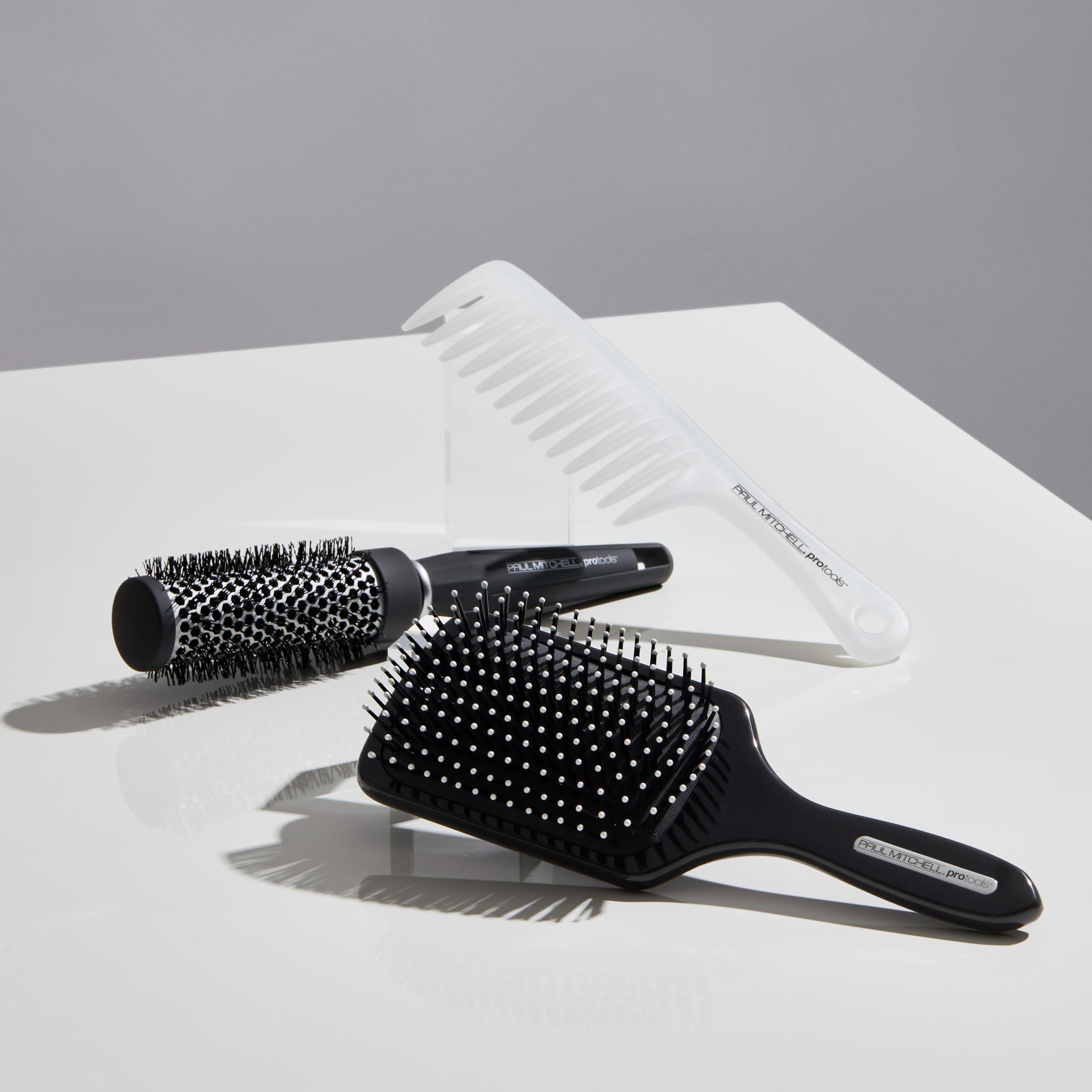 Paul Mitchell Express Ion brush in use during blow-drying to add volume and control.