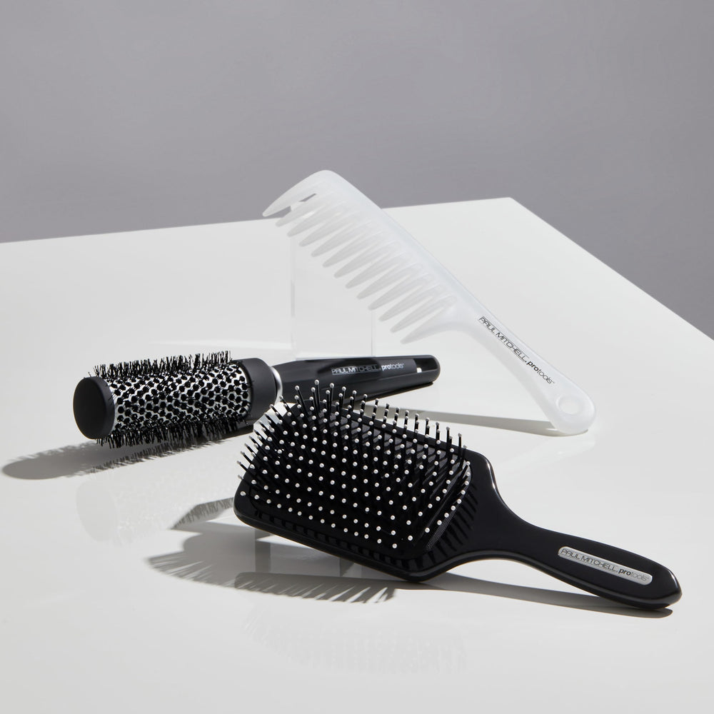 Paul Mitchell Express Ion brush in use during blow-drying to add volume and control.
