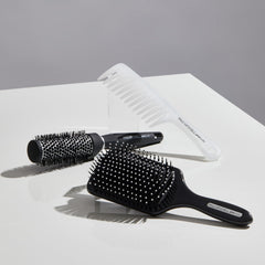Paul Mitchell Express Ion brush in use during blow-drying to add volume and control.