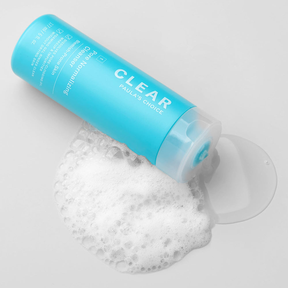 Paula's Choice CLEAR Pore Normalizing Cleanser in a bathroom setup for daily skincare routine.