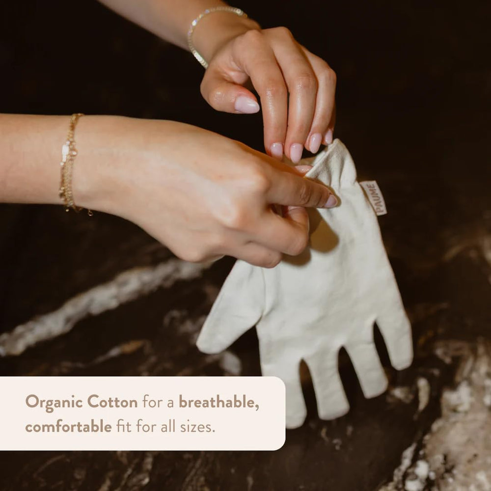 PAUME Overnight Hydration Gloves on hand by bed, promoting overnight moisture.