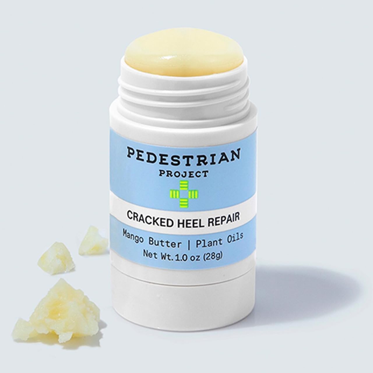Pedestrian Project heel balm applying to a rough heel in soft, hydrated finish