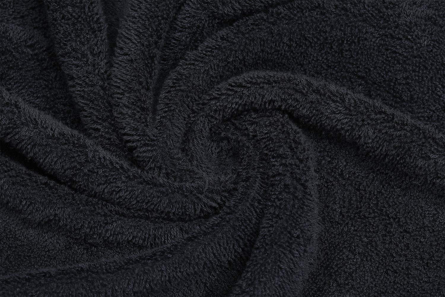 PERFEHAIR Black Salon Towels draped over a spa table emphasize spa-grade softness.