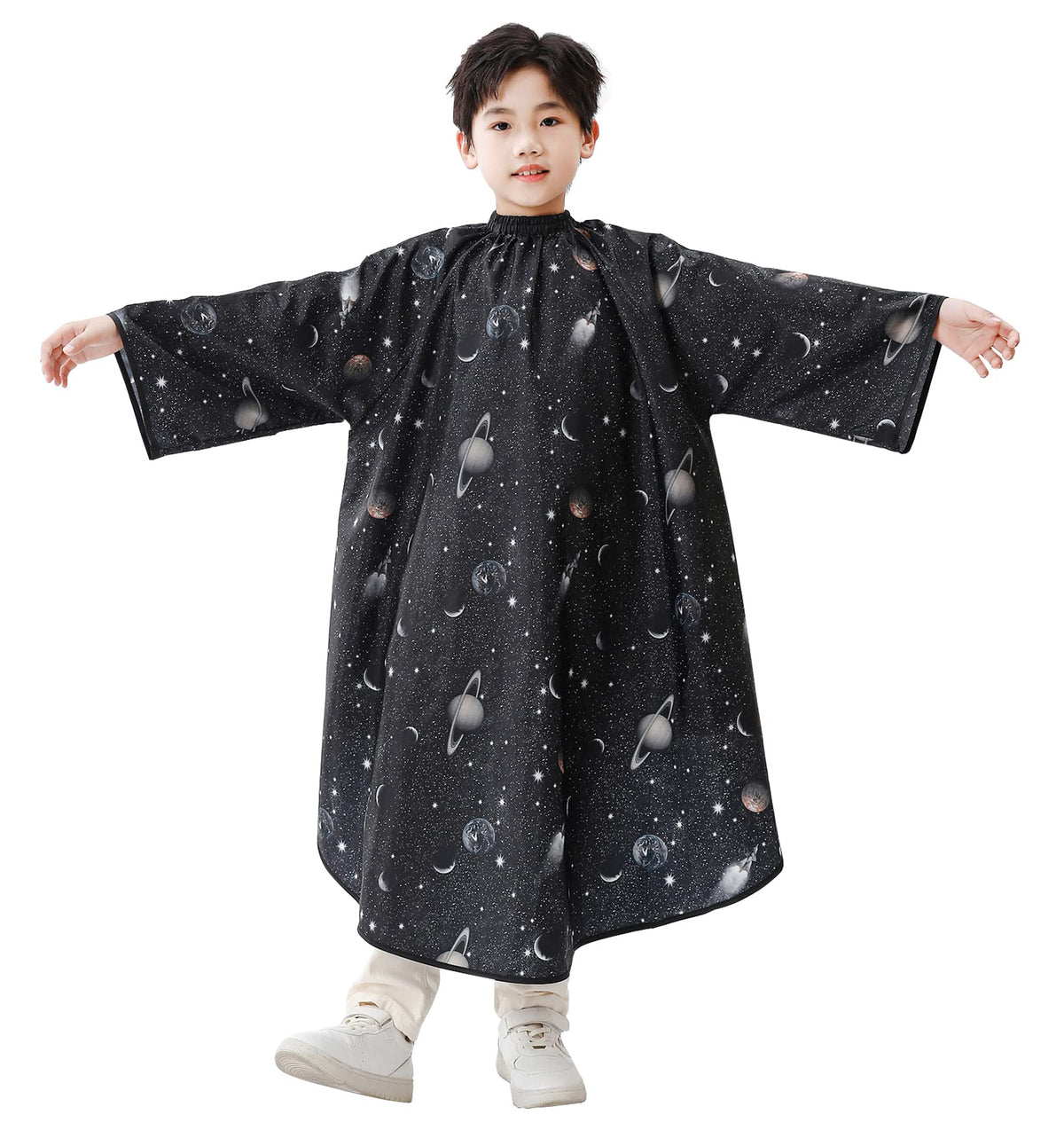 PERFEHAIR kids cape with sleeves, space print, showing comfortable neck closure and front coverage.