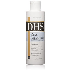 Person and Covey DHS Zinc Shampoo bottle highlights soothing scalp relief and nourishment.