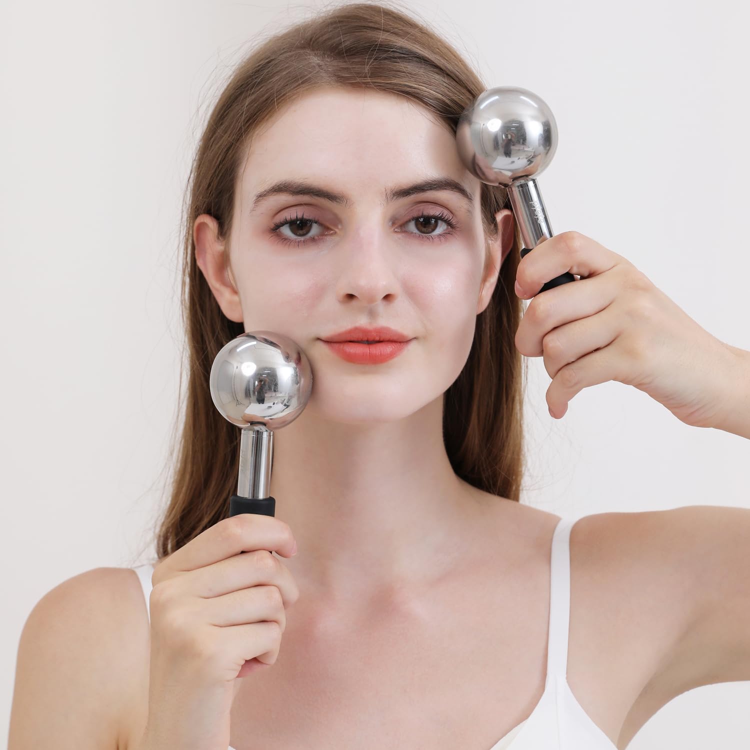 Pfefe ice globes gliding over cheeks for relaxing cooling massage