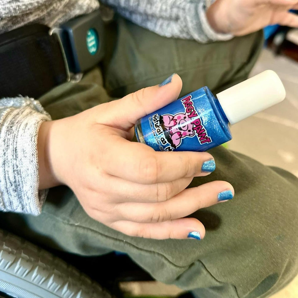 Piggy Paint Mermaid in the Shade nails with royal blue glitter for mermaid-inspired fun.