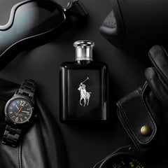 Polo Black bottle on a reflective surface signaling premium fragrance.