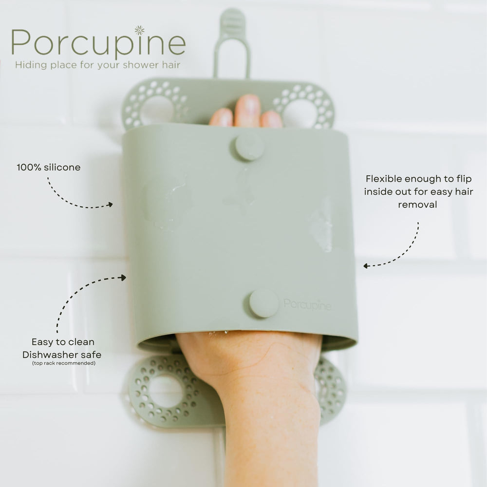 Porcupine shower wall hair catcher with suction cups mounted on wall surface.