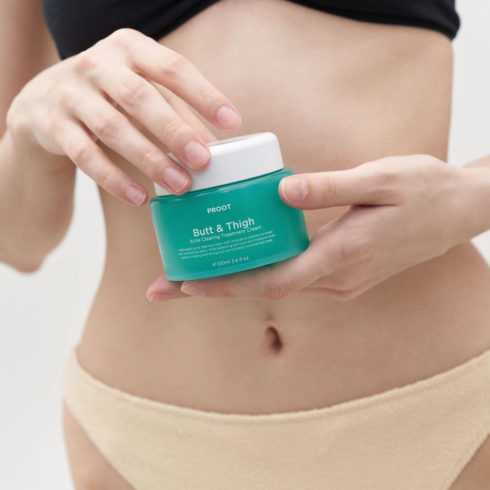 PROOT Butt Acne Cream travel-sized packaging beside other products