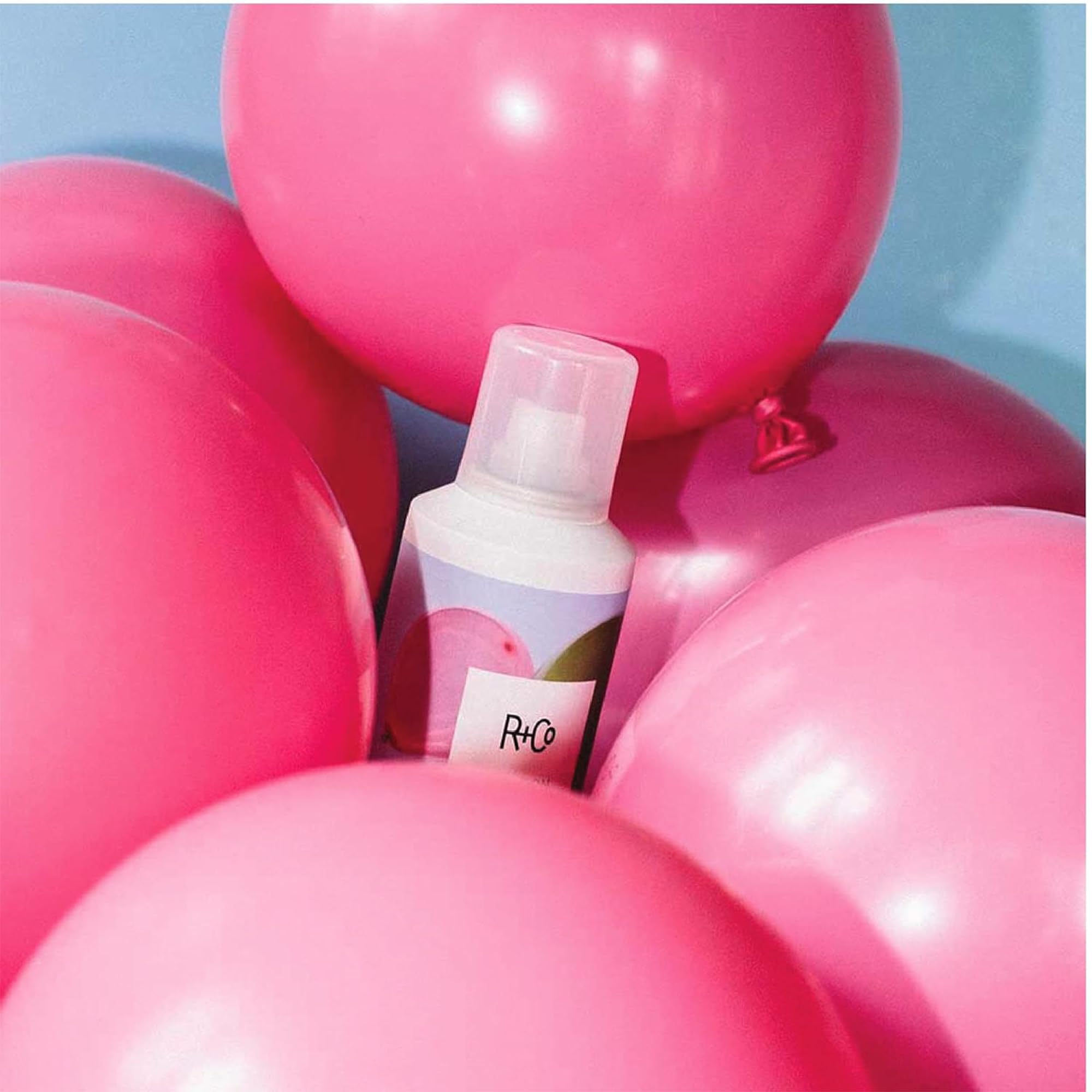 Hands styling hair with Balloon to create texture and volume.