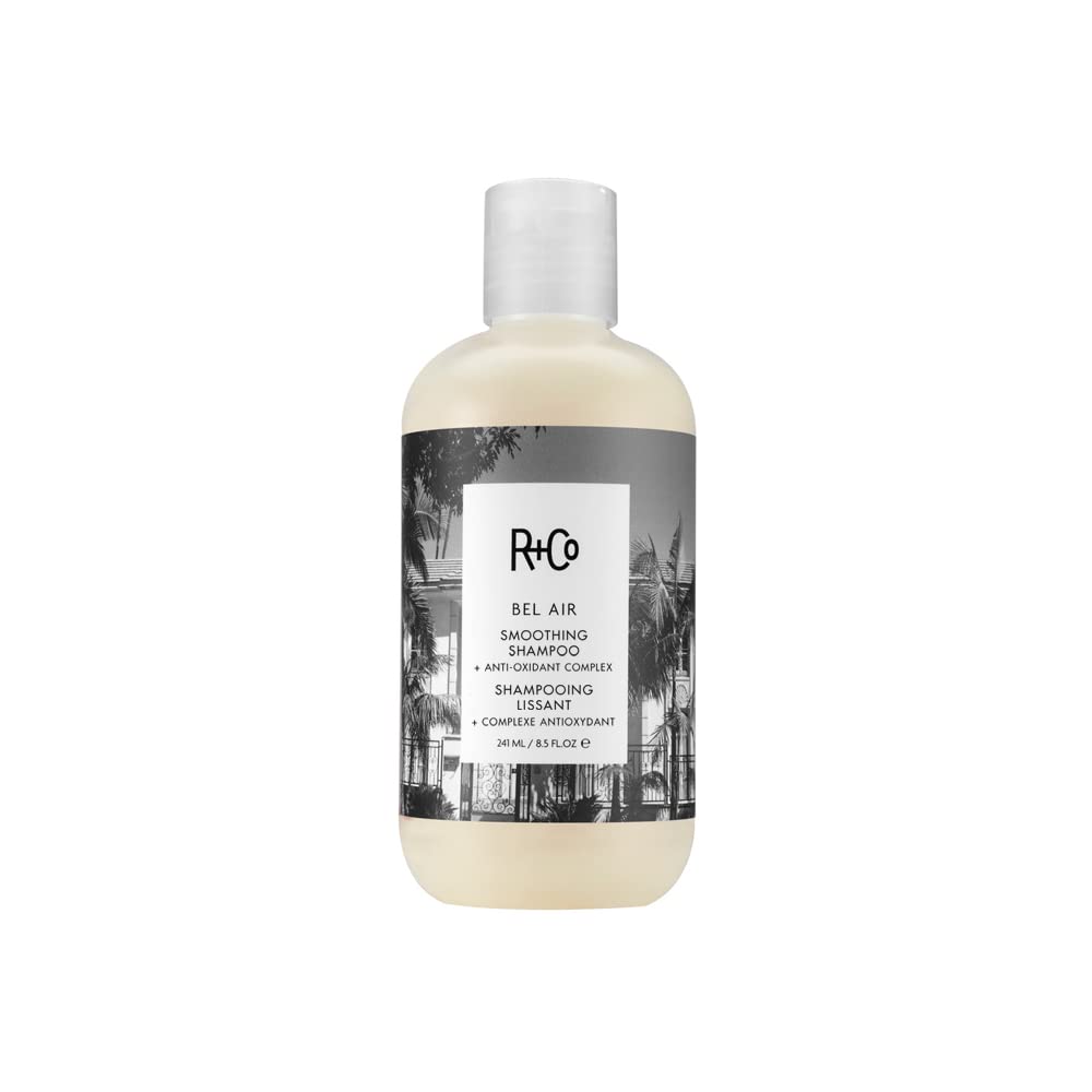 R+Co Bel Air shampoo bottle demonstrates smoothing formula for a sleek, frizz-controlled finish.