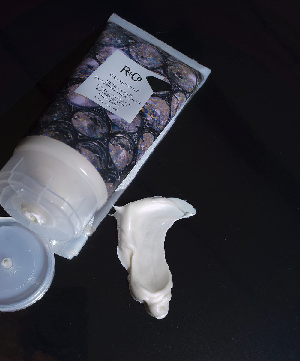 Glossy strand under UV light demonstrates R+Co Gemstone Ultra Shine protection.