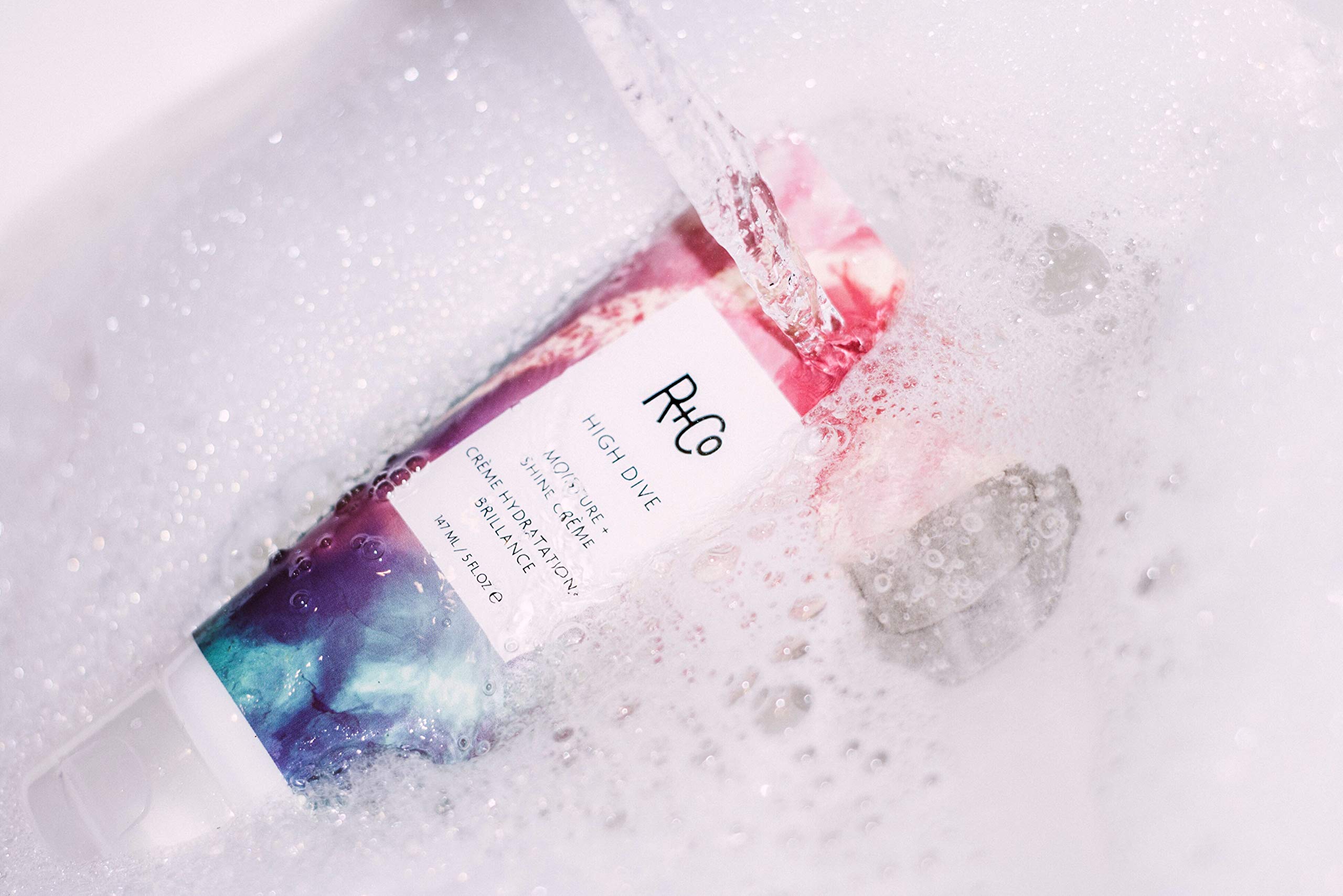 R+Co High Dive sunflower-extract image implies moisture locking for protection.