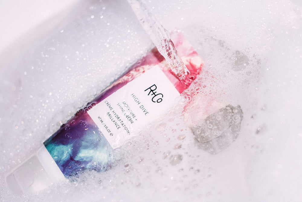 R+Co High Dive sunflower-extract image implies moisture locking for protection.