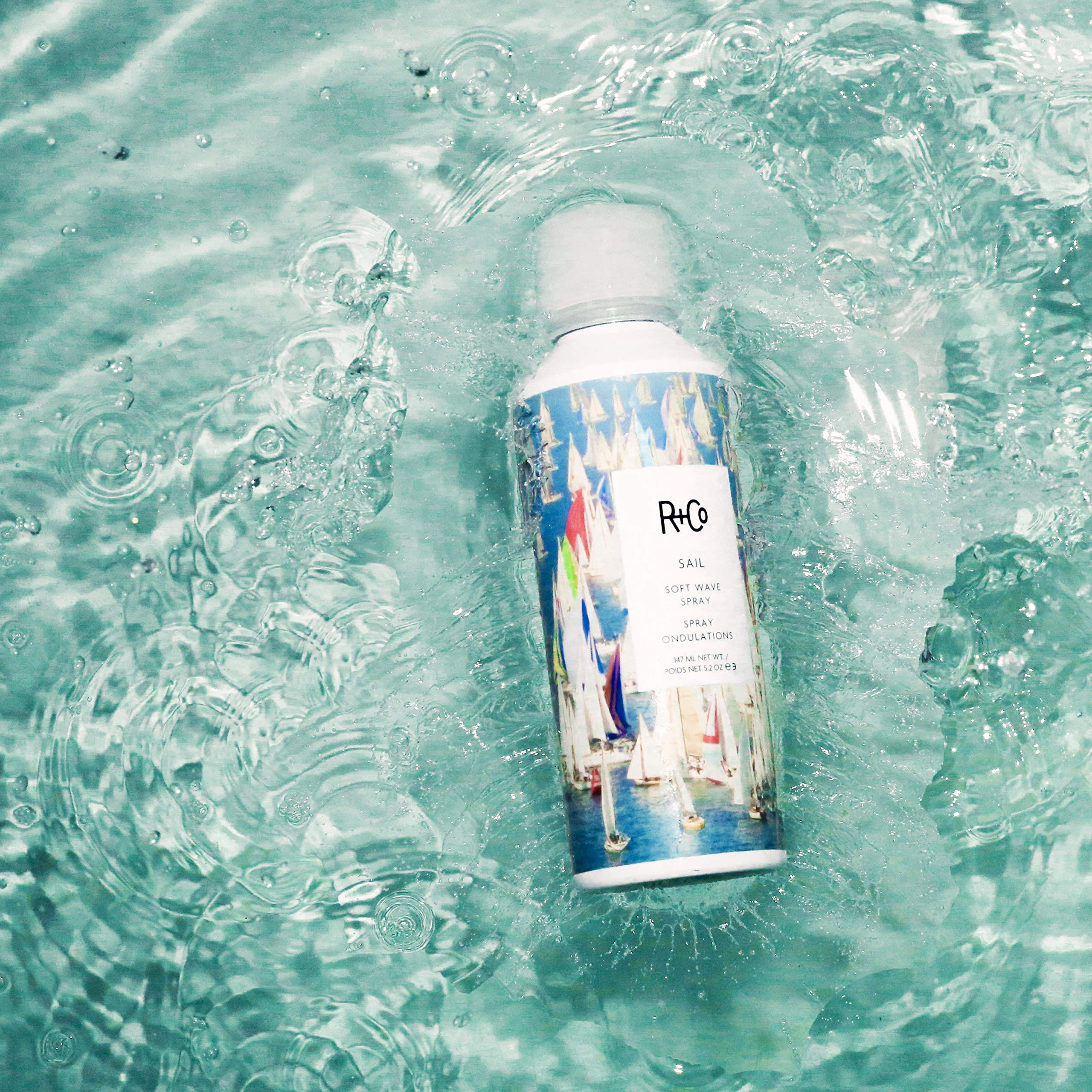 Hands applying Sail Soft Wave Spray for effortless waves and shine