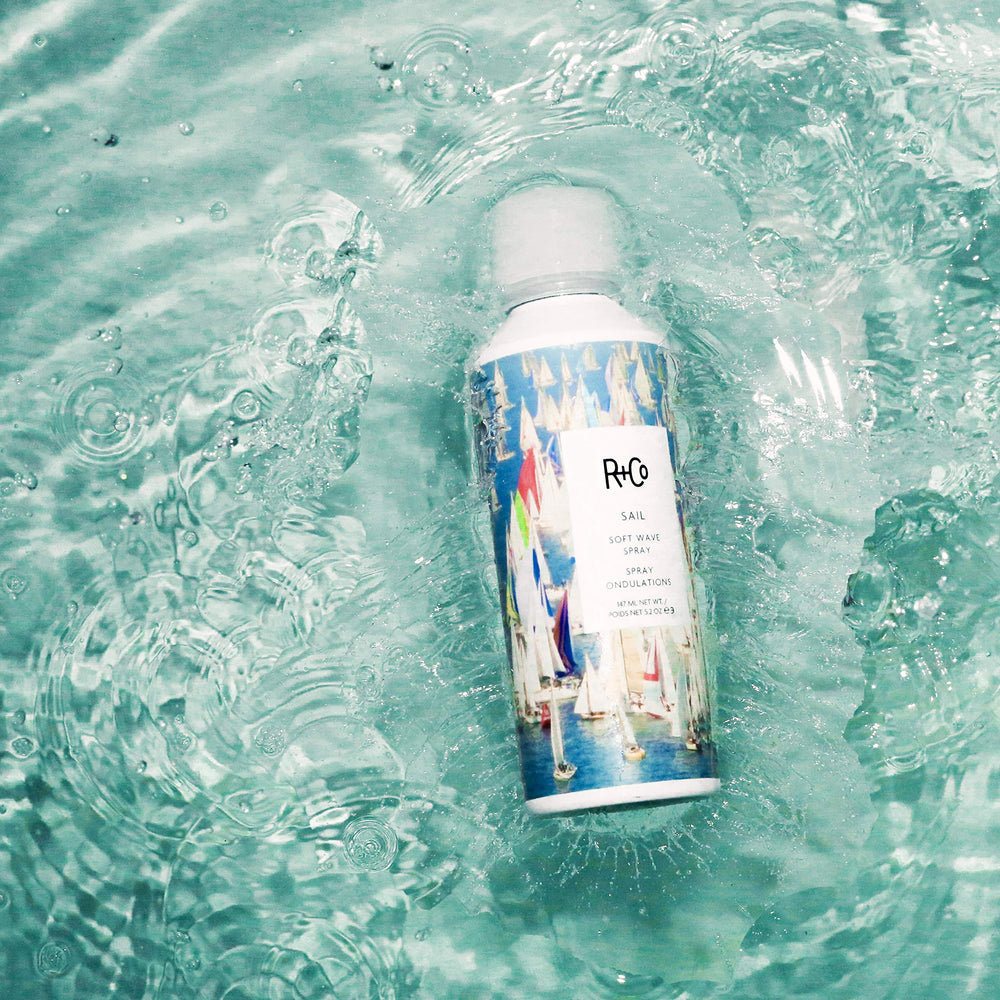 Hands applying Sail Soft Wave Spray for effortless waves and shine