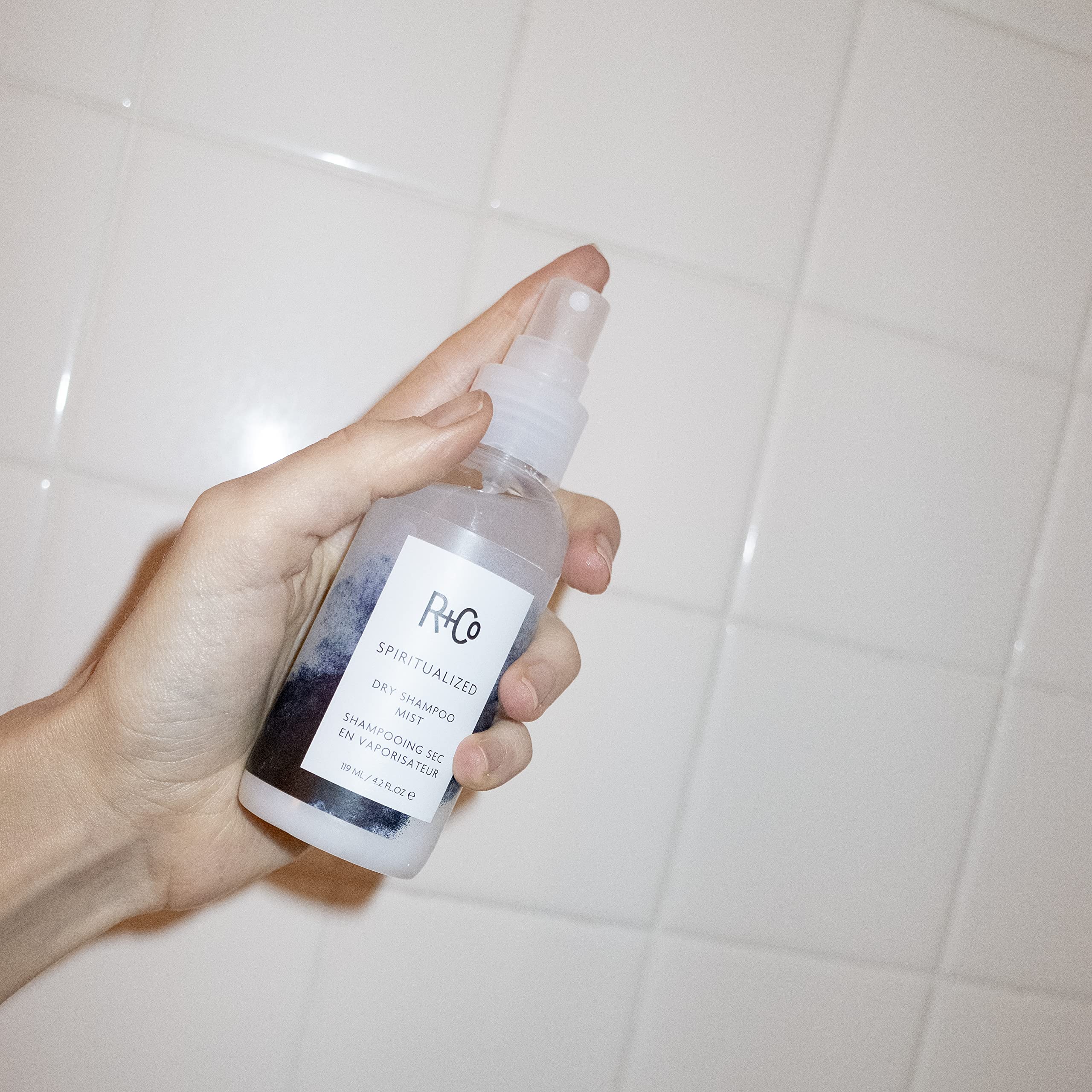 R+Co Spiritualized Dry Shampoo Mist being used after a workout for fresh hair.