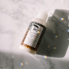 R+Co Sun Catcher Power C Leave-In bottle back highlights lightweight conditioning for hair.