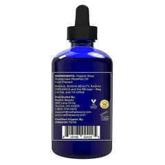 Radha Beauty Rosehip Seed Oil bottle applying on hair for shine.
