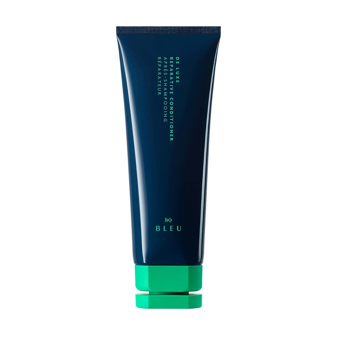 R+Co BLEU De Luxe conditioner bottle pouring for smooth, hydrated hair.