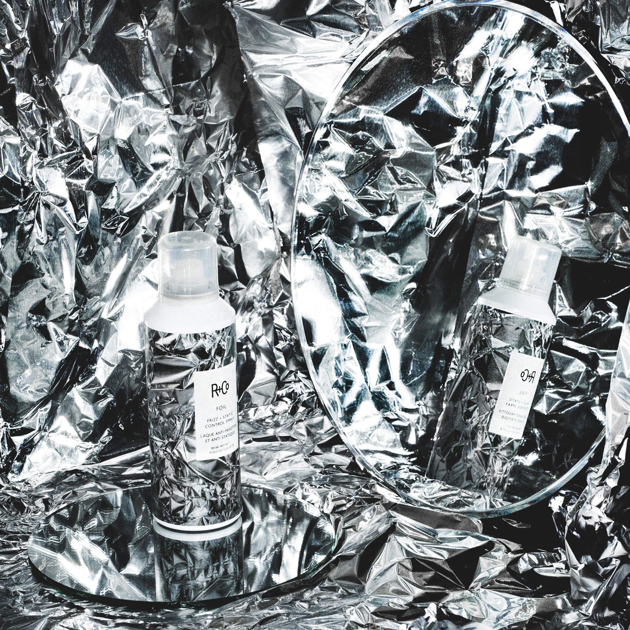 R+Co Foil Frizz Static Spray application on hair shows flexible control against frizz.