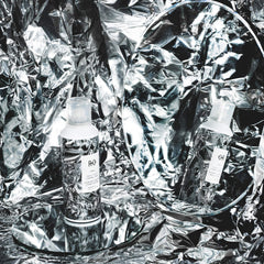 R+Co Foil Frizz Static Spray application on hair shows flexible control against frizz.