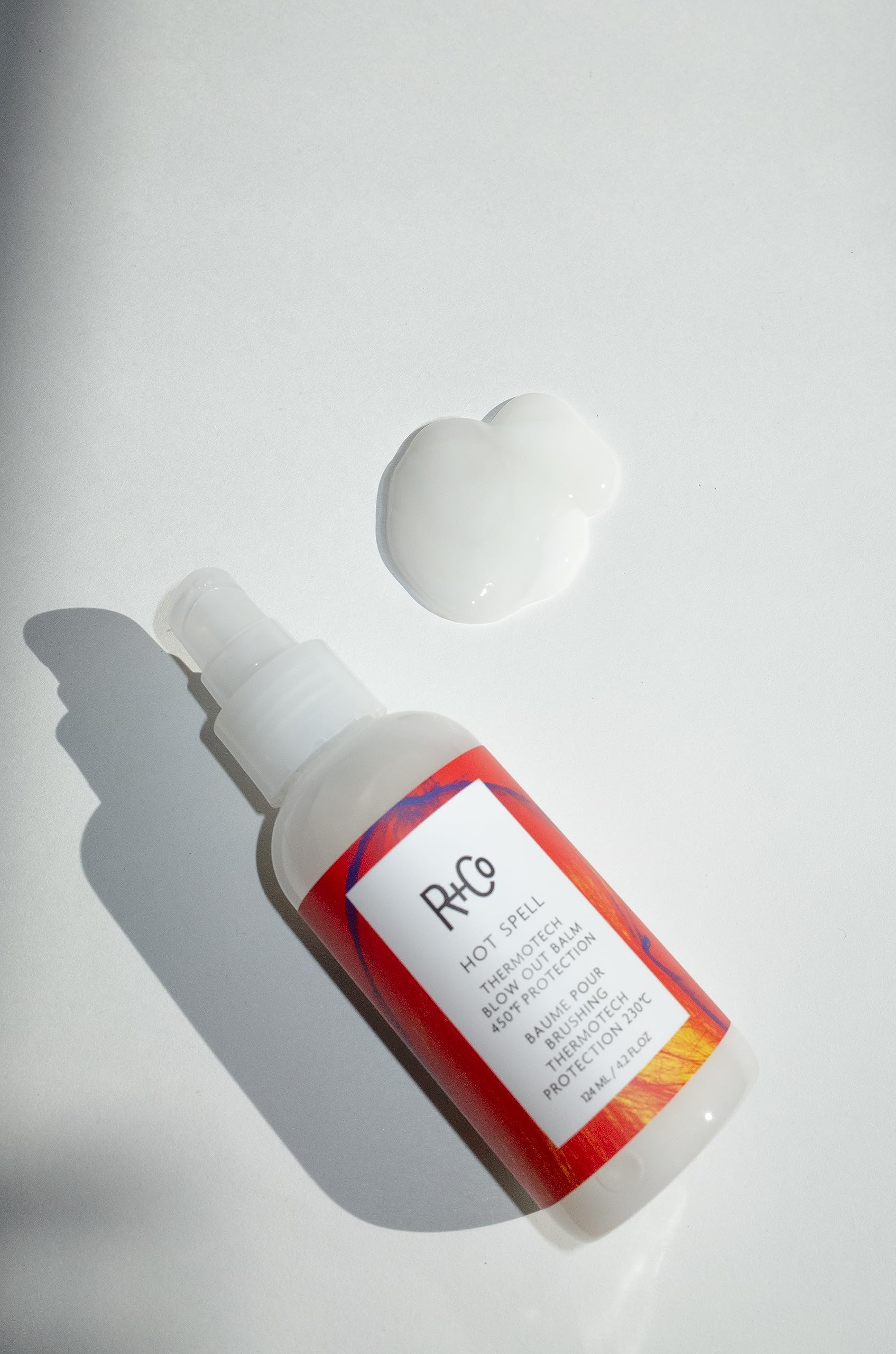 R+Co Hot Spell balm texture close up shows silky cream for even application