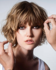 R+Co SUN CATCHER mist applied to hair for frizz control and shine.