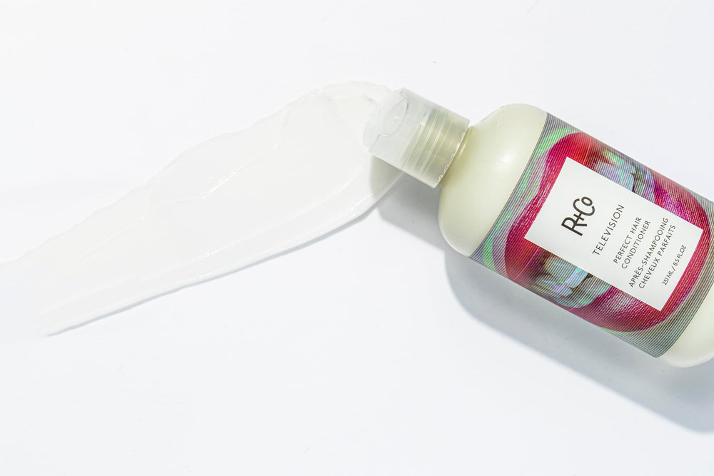 R+Co Television conditioner on bathroom shelf evokes salon-grade smoothing and conditioning