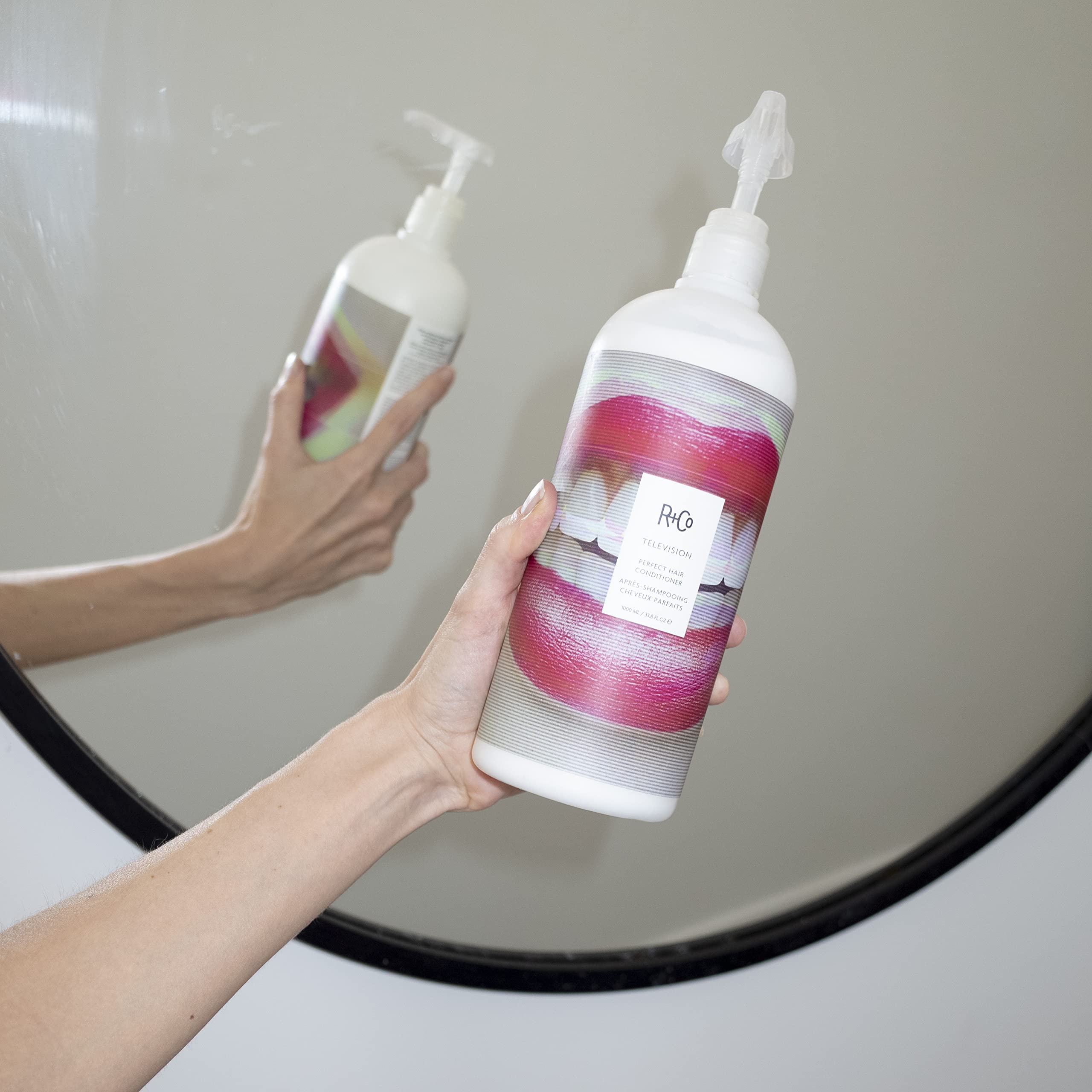 R+Co Television Perfect Hair Conditioner pump demonstrates easy application for smooth, frizz-controlled hair.
