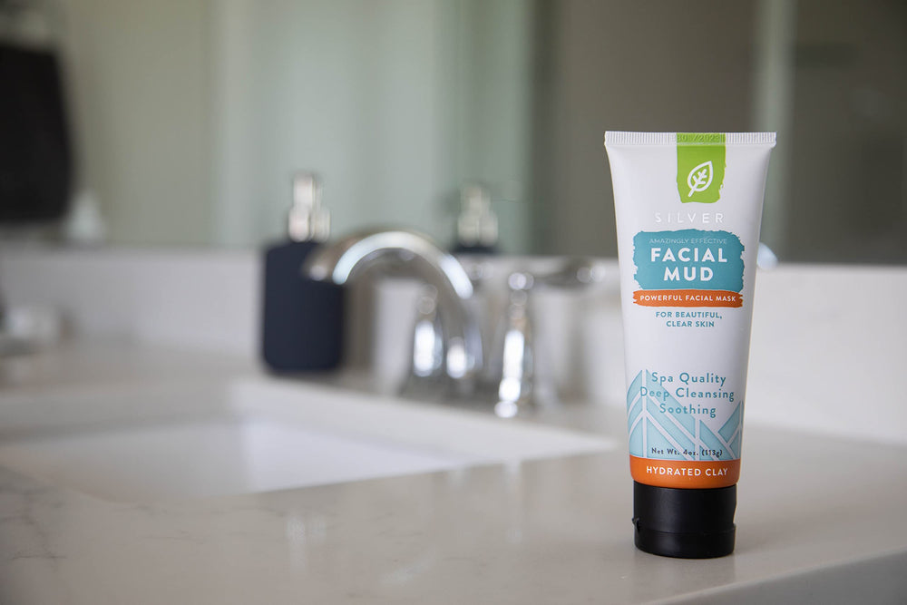 Redmond Bentonite clay mask application on face suggesting detoxifying pore cleanse.