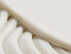 REVERIE conditioner jar close-up shows creamy texture for gentle nourishment.