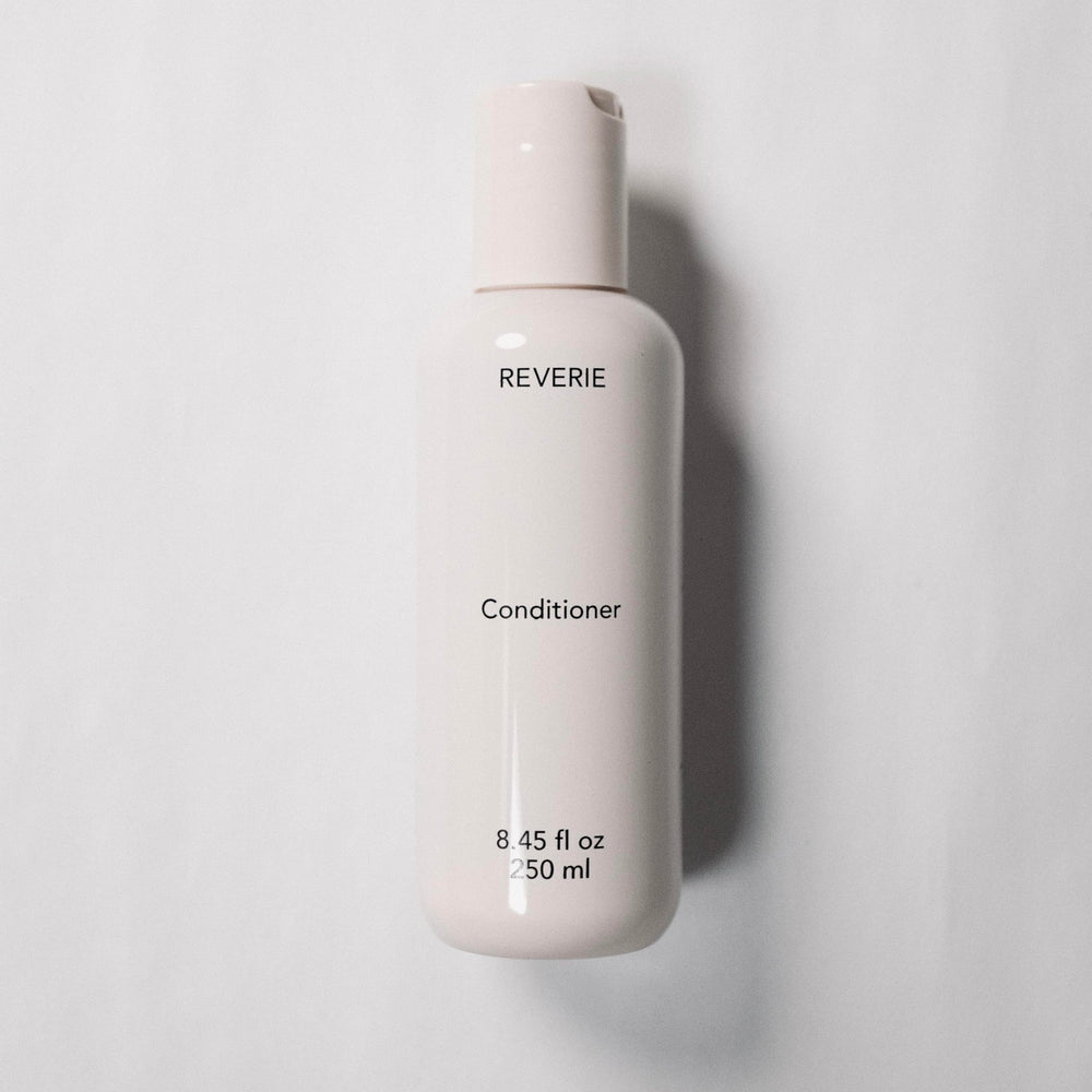REVERIE conditioner application on hair demonstrates slip and detangling ease.