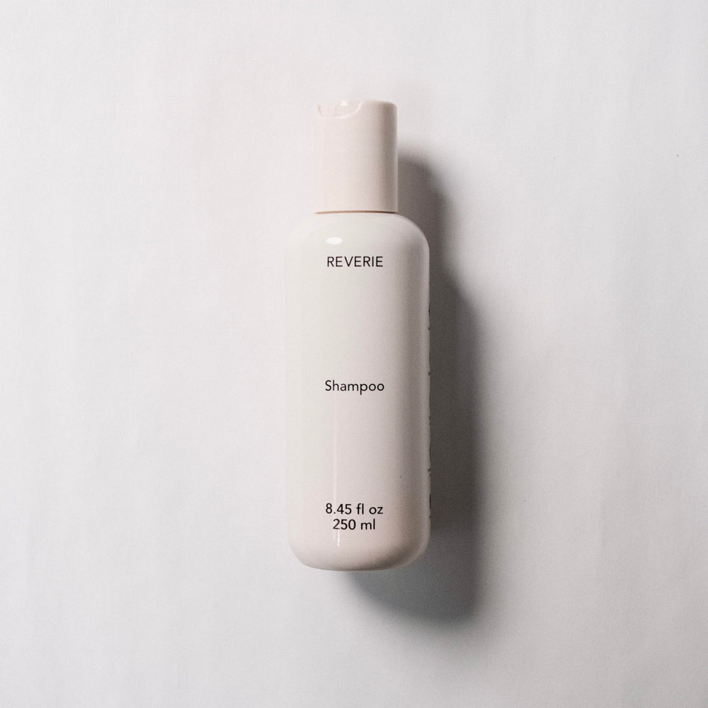 REVERIE Natural Balancing Shampoo lather demonstrates gentle cleansing that preserves moisture.