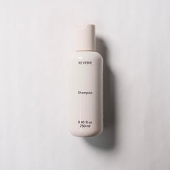 REVERIE Natural Balancing Shampoo lather demonstrates gentle cleansing that preserves moisture.