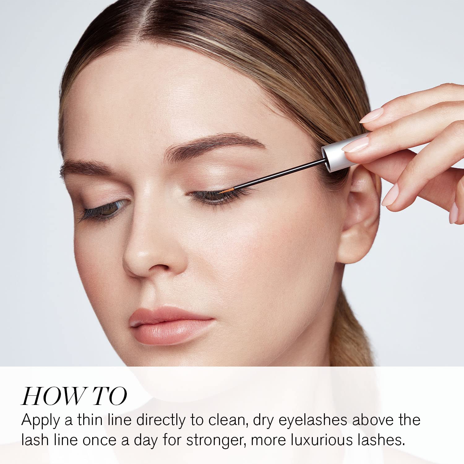 RevitaLash close-up brush applying serum to lash line, supports stronger healthier lashes