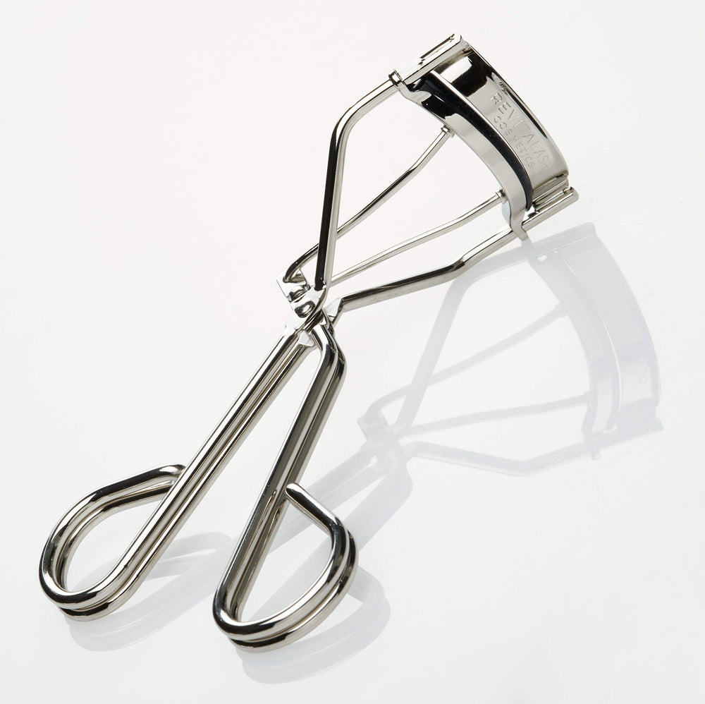 RevitaLash curler in use near lashes demonstrating safe lift benefit