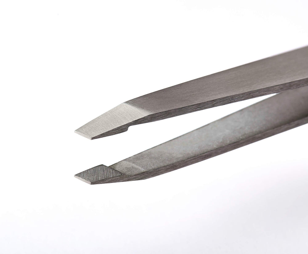 RevitaLash tweezers on sterilization tray indicating salon-ready hygiene and longevity
