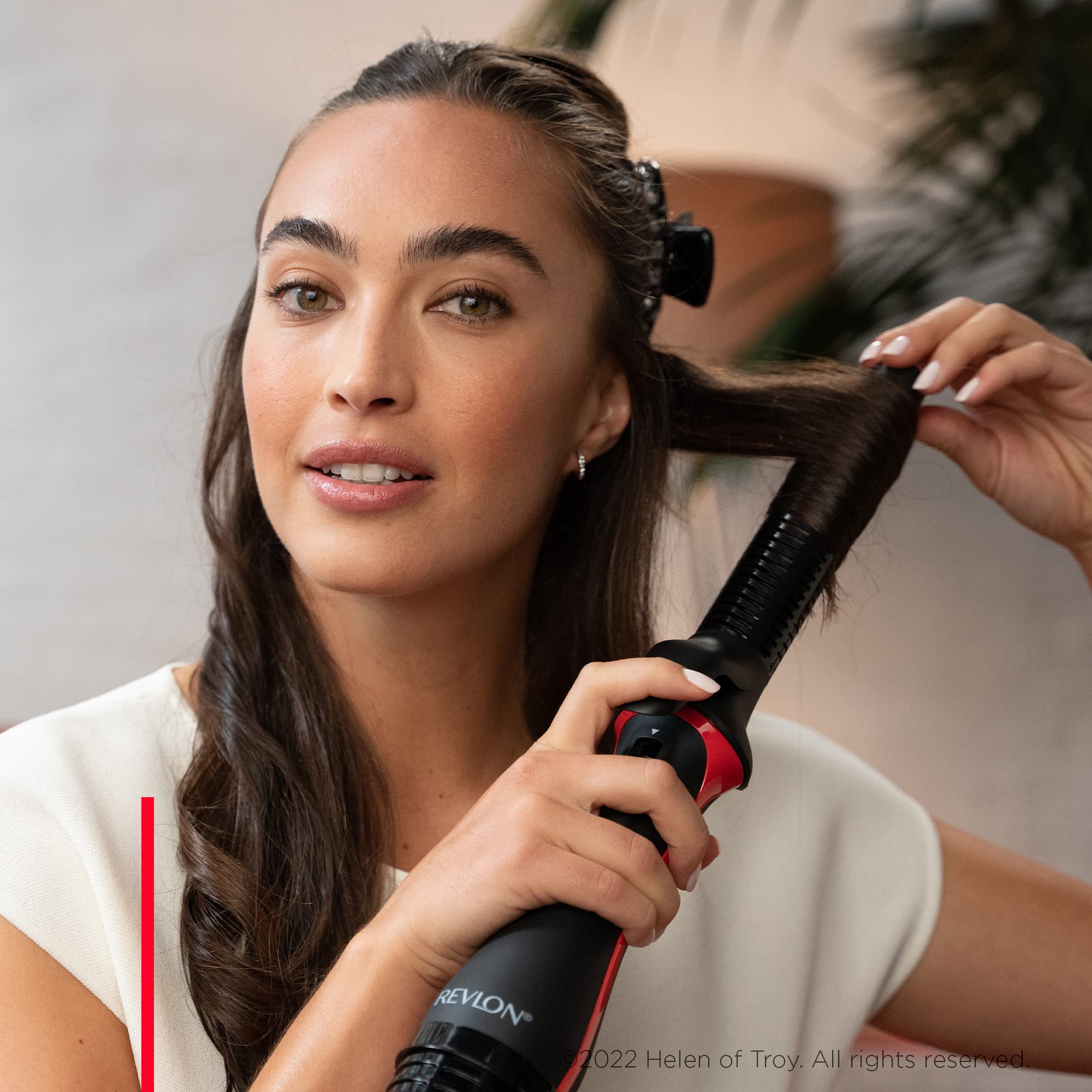 REVLON One-Step Blowout Styler with four heat settings for customizable styling.
