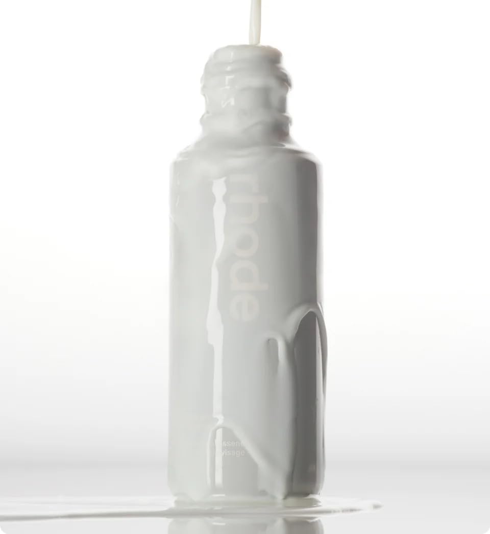 Rhode Glazing Milk hands-press shows gentle application for improved absorption.