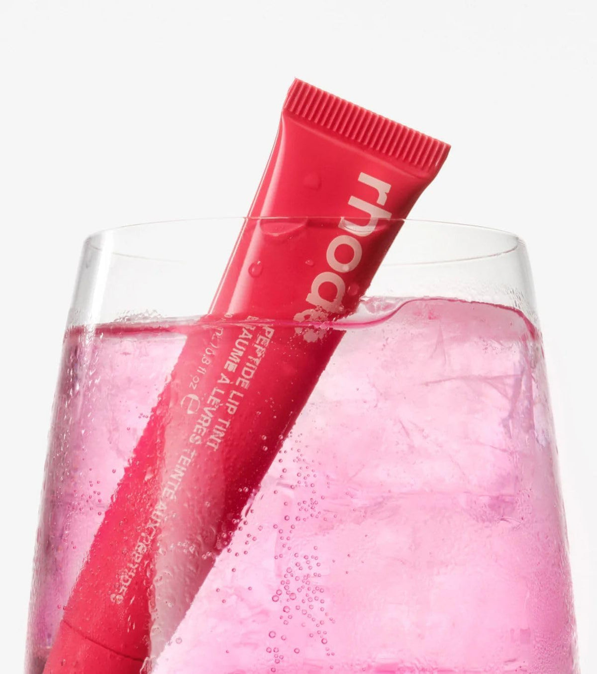 Rhode Guava Spritz bright coral tube for easy lip tint application