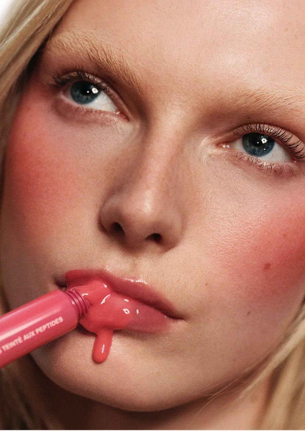 Rhode Guava Spritz lip-tint-swirl-on-lips showcasing glossy buildable color