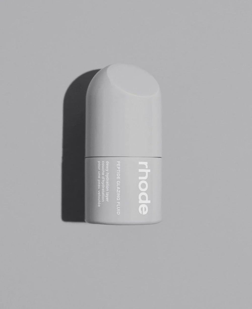 Rhode peptide glazing fluid bottle closeup in white packaging for luminous skin