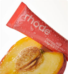 Rhode Peach Pit clear-gloss swatch emphasizing hydrating fragrance-free formula.