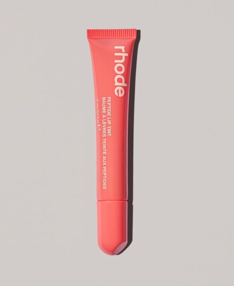 Rhode Peach Pit lip tint application swatch with clear tint and glossy finish.